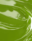 Close-up view of a green liquid candle dye.