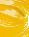 A close-up image of a lemon yellow colored liquid candle dye by Sozo Essentials.