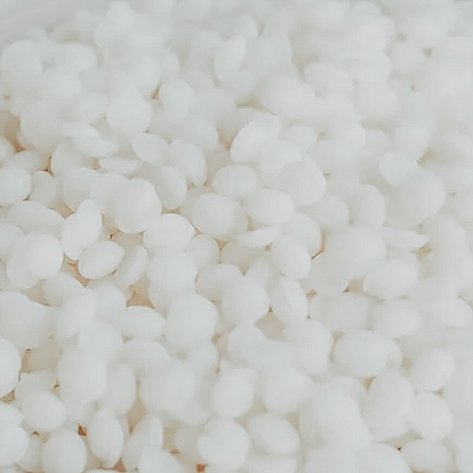 A close-up image of white soy wax pellets.