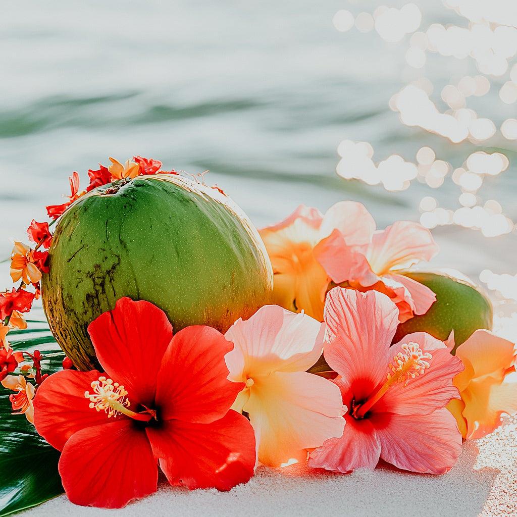 A fragrance oil bottle with a tropical theme, featuring an image of a coconut, hibiscus flowers, and other tropical elements.