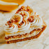 Slice of banana cream pie with whipped cream and crushed cookies on a marble surface