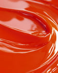 Close-up of a highly concentrated orange liquid candle dye.