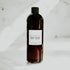 A clear bottle labeled 'BODY & HAIR MIST BASE' from Doop Fragrance Co., designed for containing custom body and hair fragrance mists.