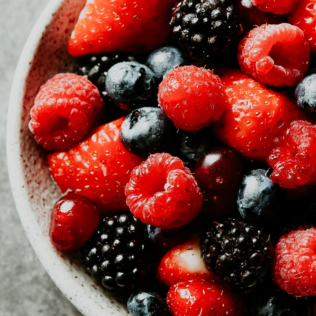 Assorted berries including strawberries, raspberries, and blackberries in a bowl.