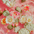 A synthetic representation of water surface with cacti and flowers, predominantly in pink tones.