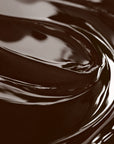 A close-up image of a chocolate brown liquid candle dye.