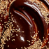 Close-up of a dessert with chocolate sauce and sesame seeds
