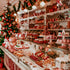 A display of various baked goods in a festive setting, likely part of a Christmas bakeshop.