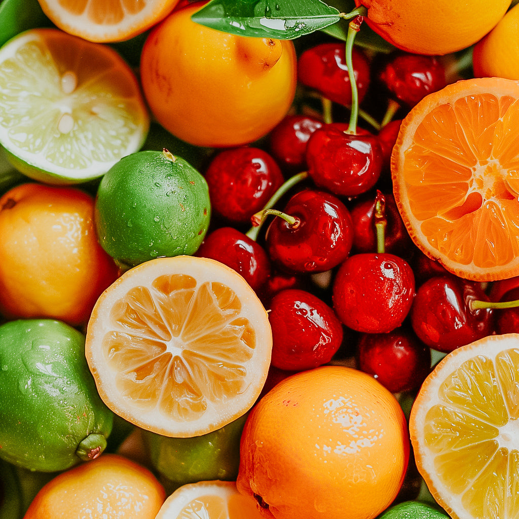 A variety of fresh fruits including oranges, lemons, limes, cherries, and nectarines arranged closely together.