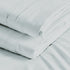 A folded white Egyptian cotton sheet with detailed stitching.