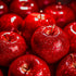 A close-up image of shiny, red apples with a blurred background.