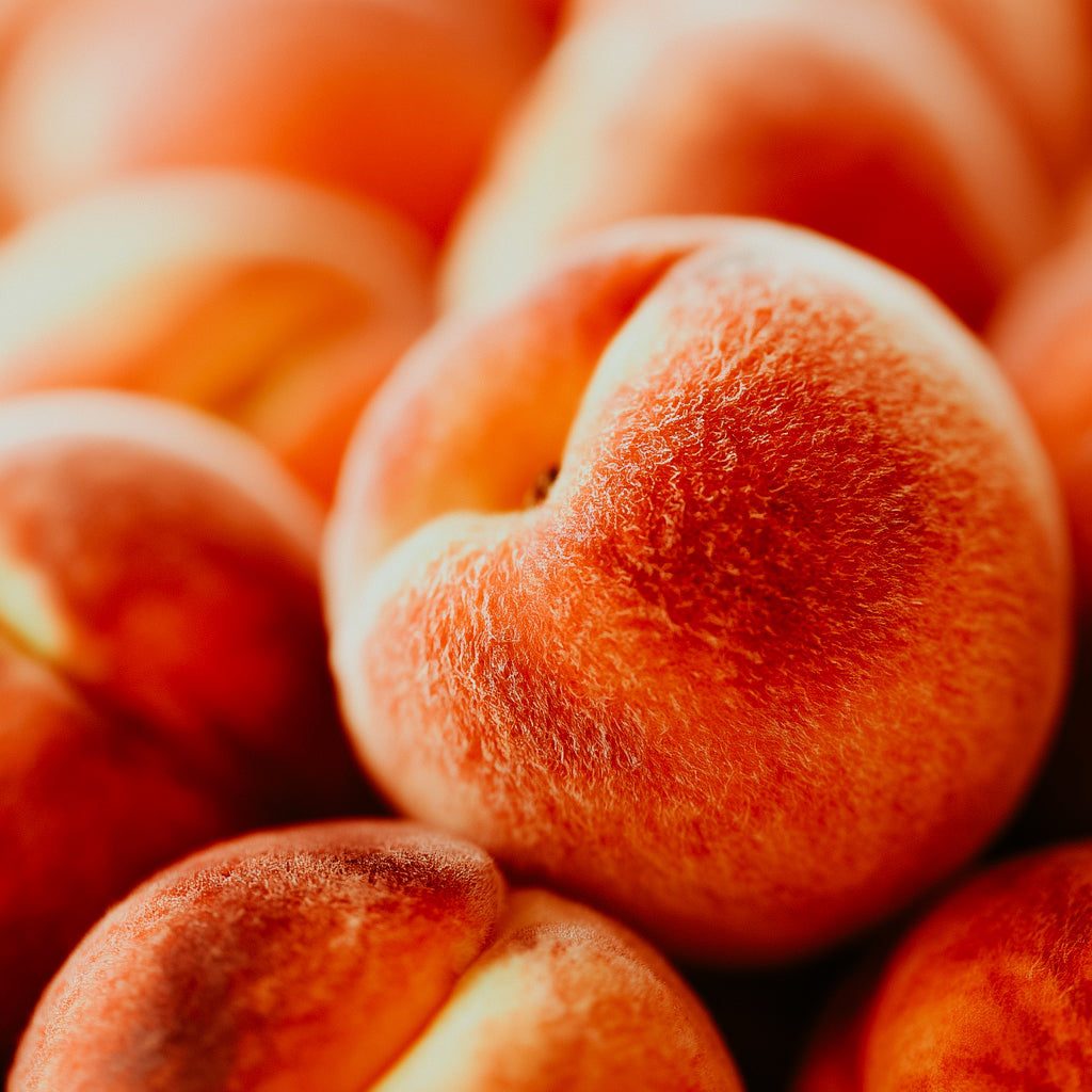 Close-up of peaches with a soft focus on texture and color.