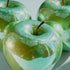 Green shiny apples on a light gray background