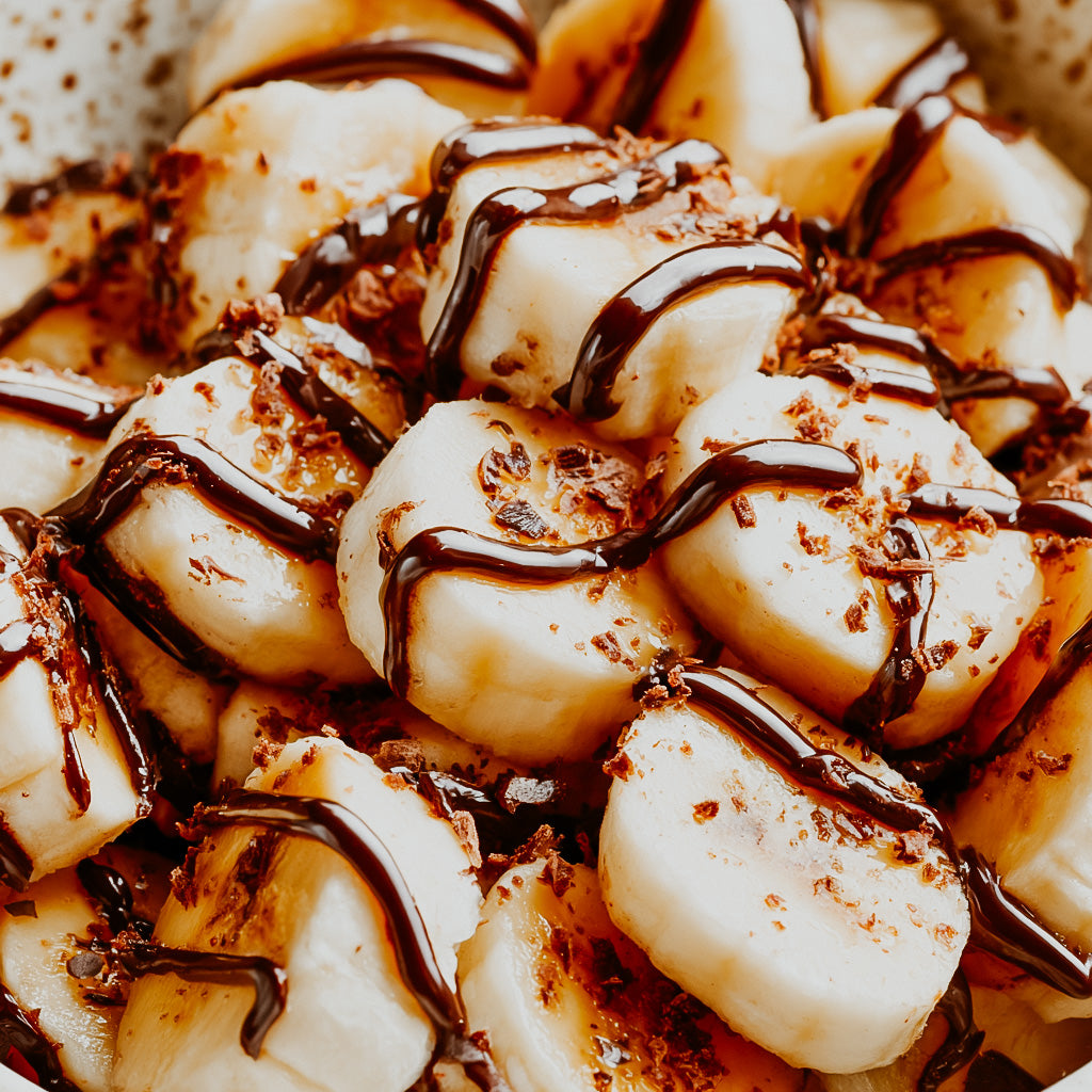 Close-up of Bananas with chocolate drizzle on a plate