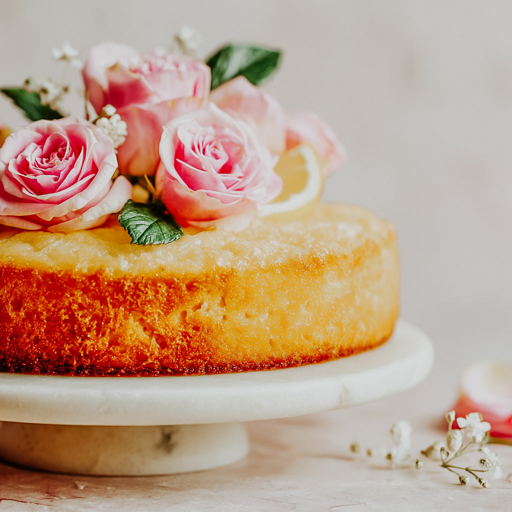 Cake with pink roses on a marble stand