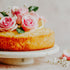 Cake with pink roses on a marble stand