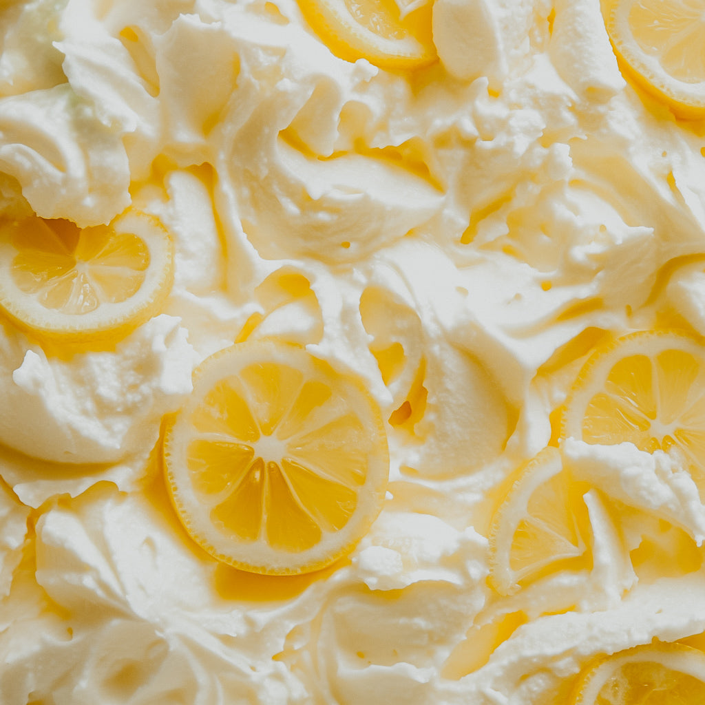 A close-up image of lemon vanilla sherbet with visible lemon slices on top.