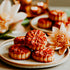 Mooncakes on a plate with flowers and candles in the background