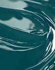 A close-up image of a teal-colored liquid candle dye.