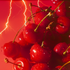 A close-up image of cherries with a vivid red background and stylized lighting that resembles electric discharge.