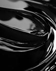 Close-up view of a highly concentrated black liquid candle dye.