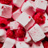 A close-up image of pink marshmallow fluff with pieces of fresh raspberry, showcasing a sweet and indulgent dessert.