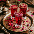 Three glasses of Rose Syrup (Rooh Afza) on a metal tray, garnished with rose petals, with a wooden background.