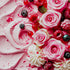 An image pink creme with pieces of berries and rose petals, evoking the scent of rose, berries, and pastries.