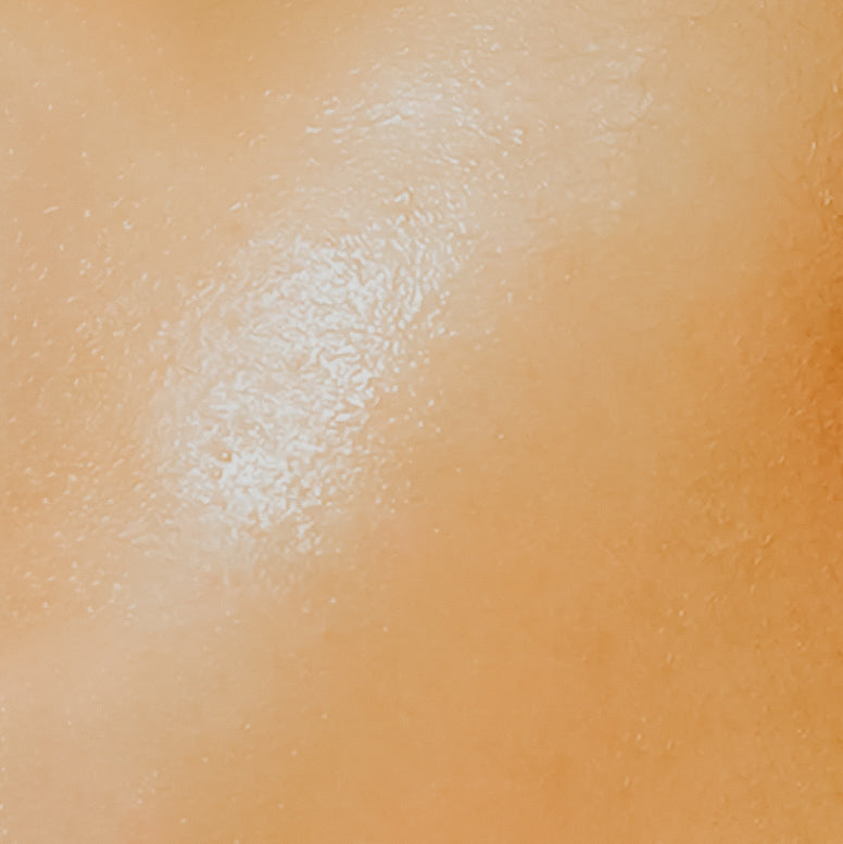 Close-up image of a person's skin, presumably to illustrate the softness achieved by using the fragrance oil.