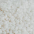 A close-up image of white soy wax pellets.