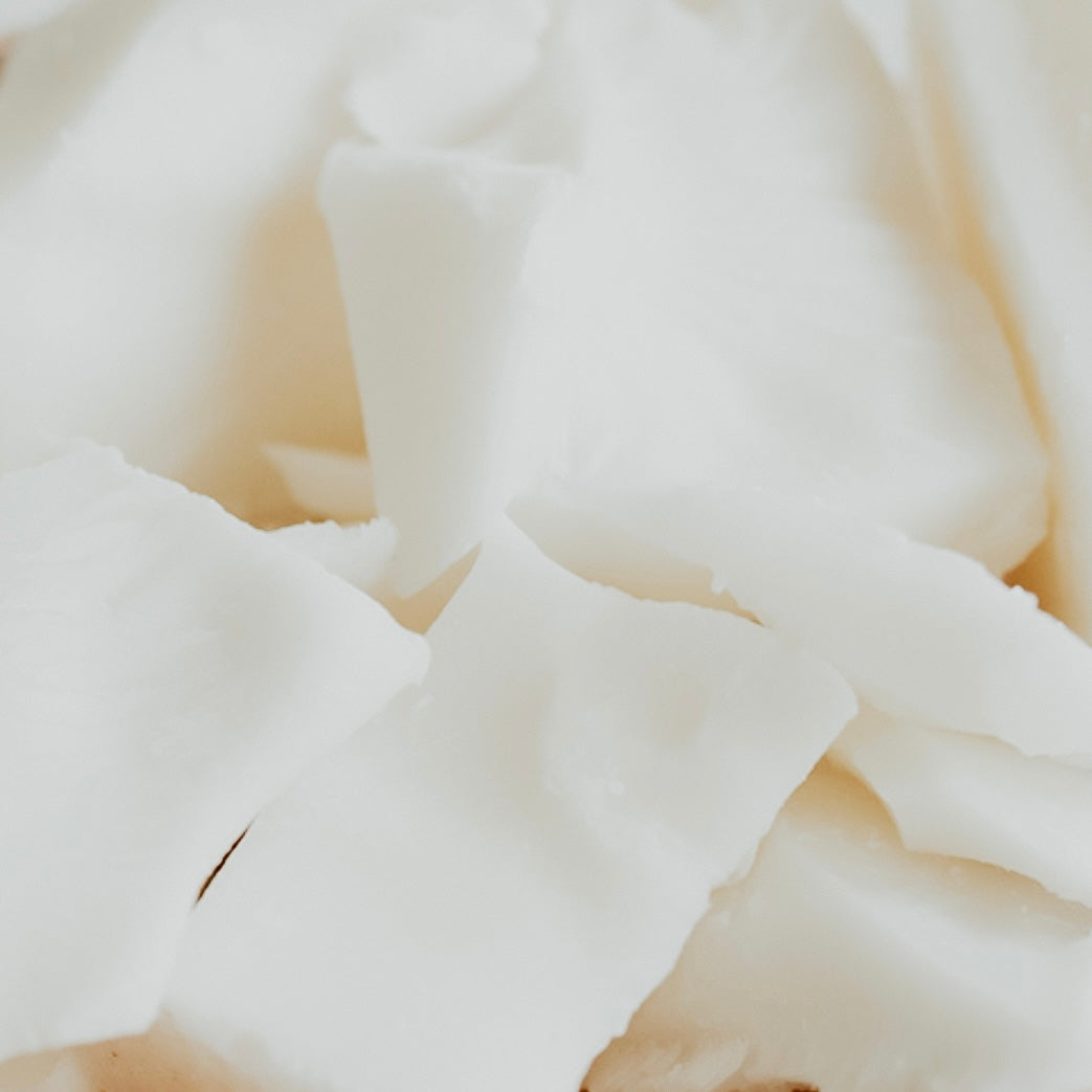 Chopped pieces of white soy-blend wax.