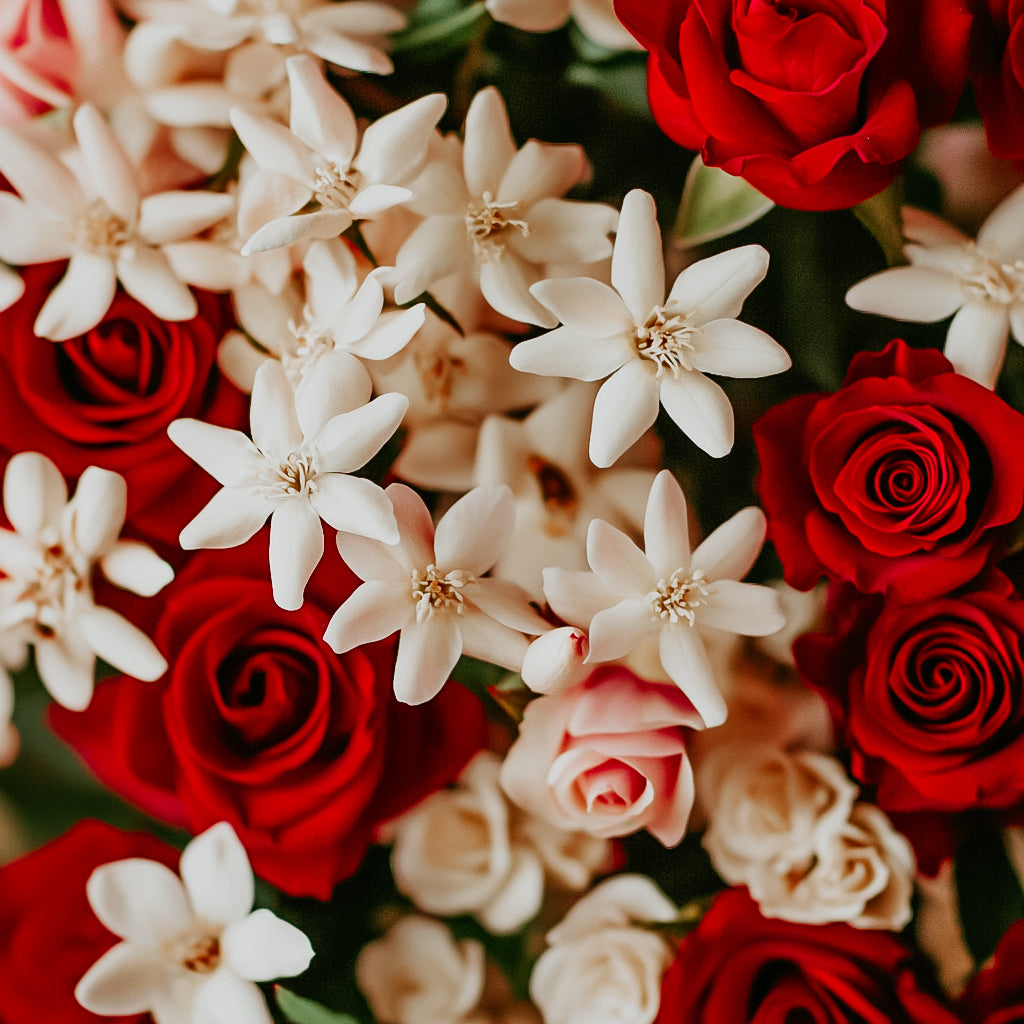 A close-up image of a bouquet with red roses and white flowers, likely representing the fragrance oil's floral scent profile.