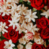 A close-up image of a bouquet with red roses and white flowers, likely representing the fragrance oil's floral scent profile.
