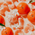Tangerines and their segments with white flowers on a light background