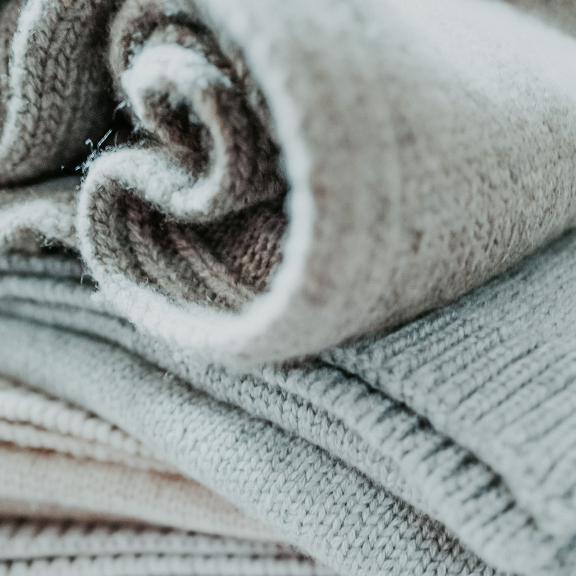 A close-up image of a grey cashmere sweater with a focus on texture.