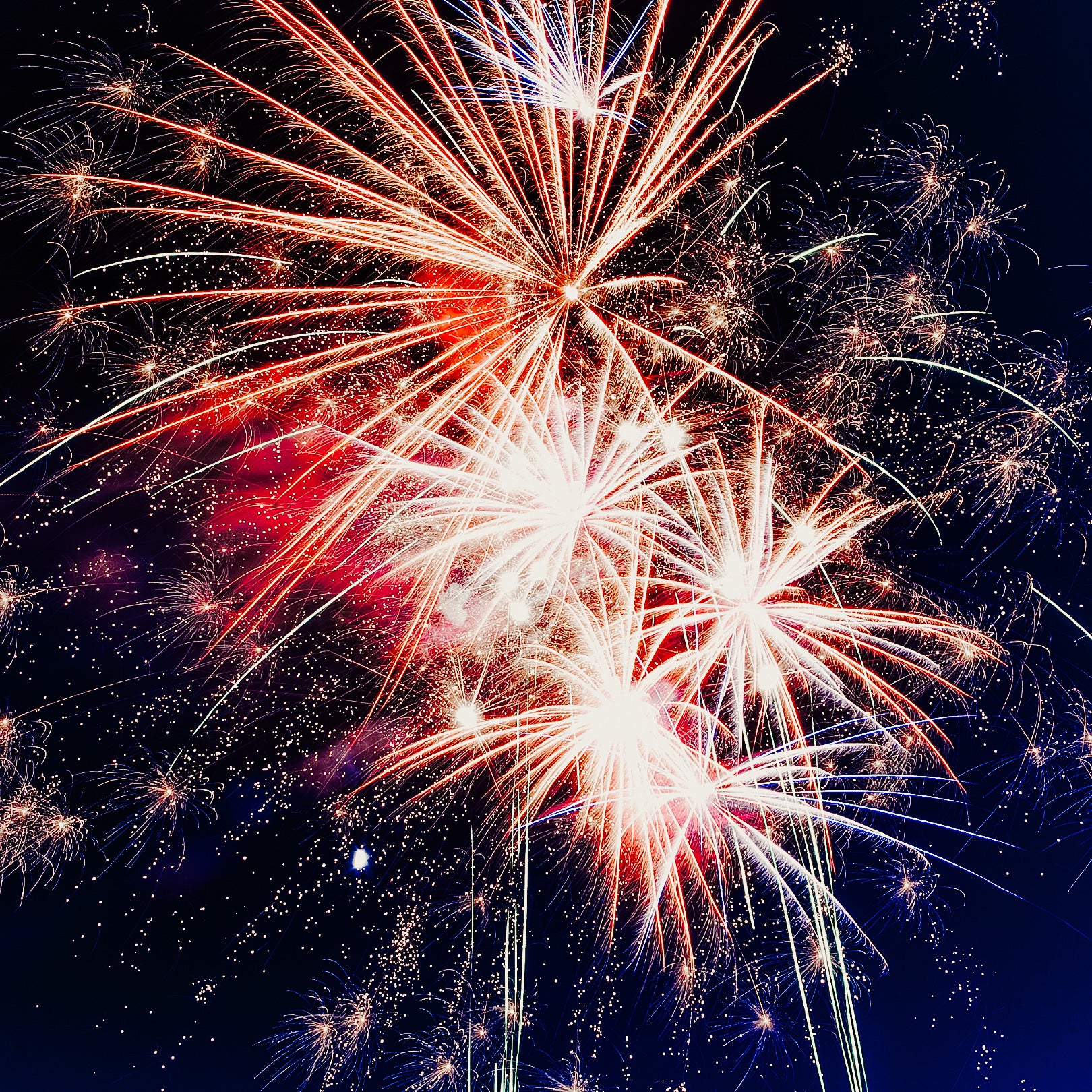 A vibrant image of fireworks displaying a variety of colors against a dark sky.