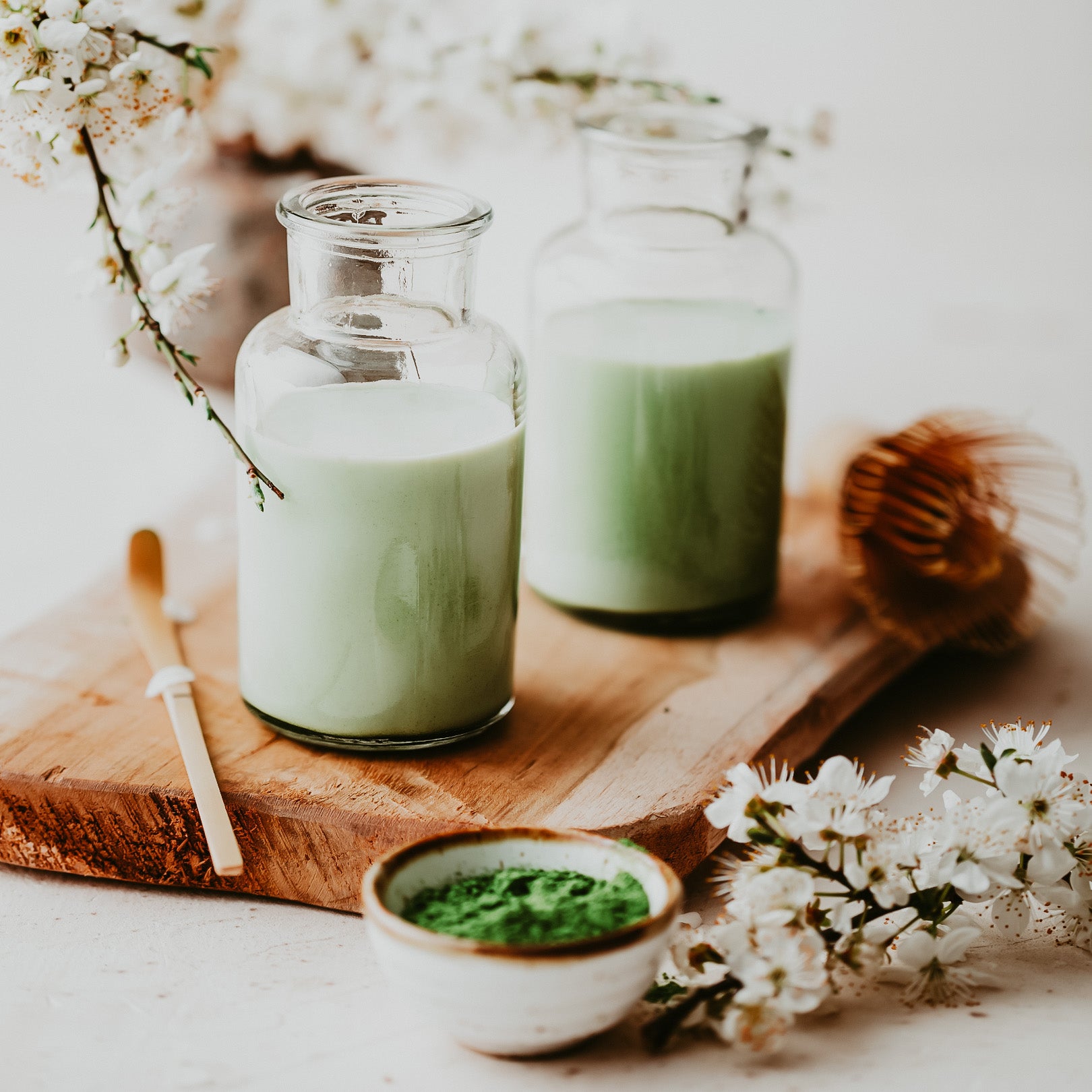 Matcha Milk with matcha blossoms in background